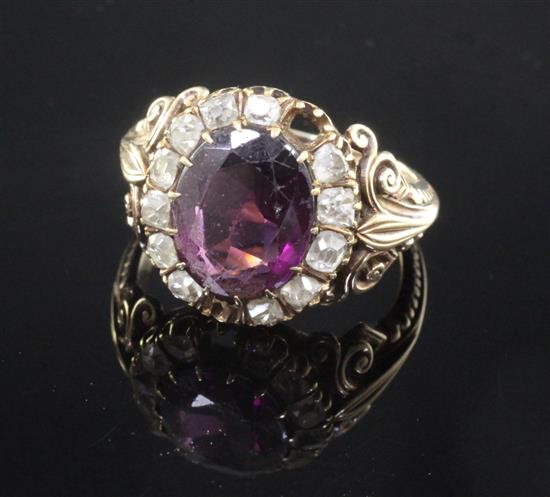 A 19th century gold rhodolite? garnet and rose cut diamond oval dress ring, size Q.